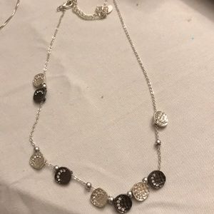 Silver necklace with black and silver decorations